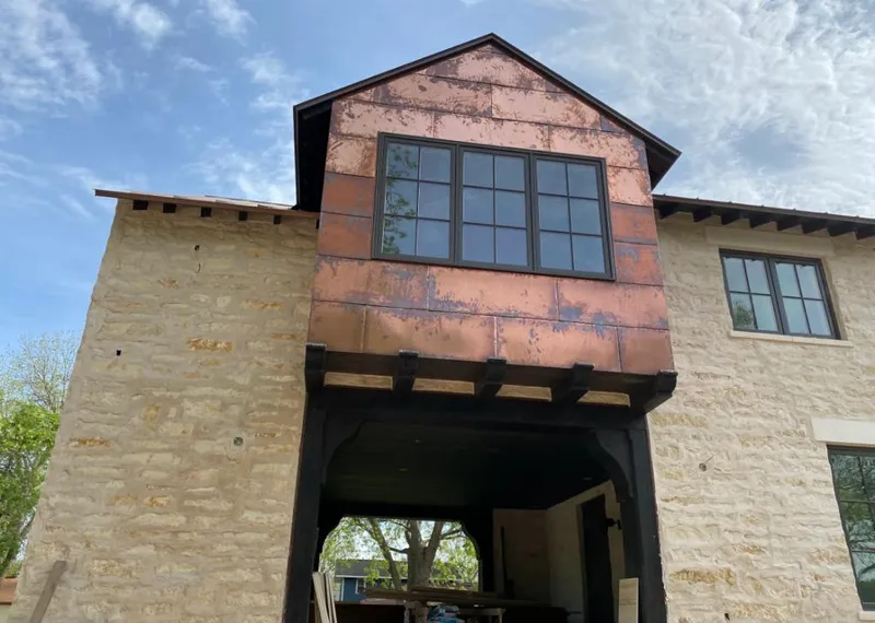 Copper metal panel facade on a stone building for Skylight Installation in Centerville